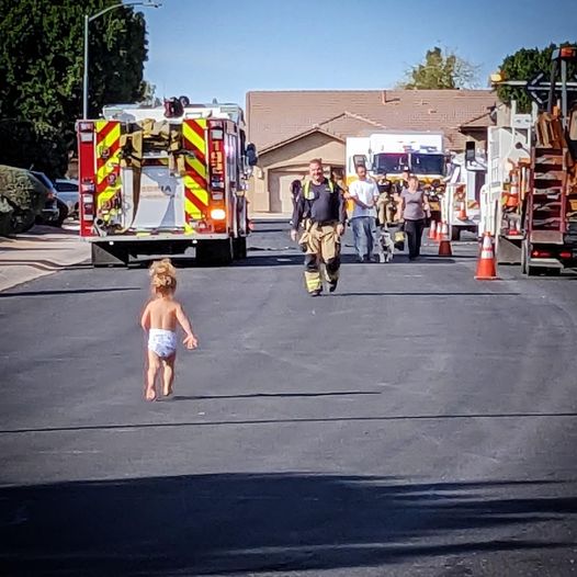 The kid runs into the arms of his hero father, who works as a firefighter
