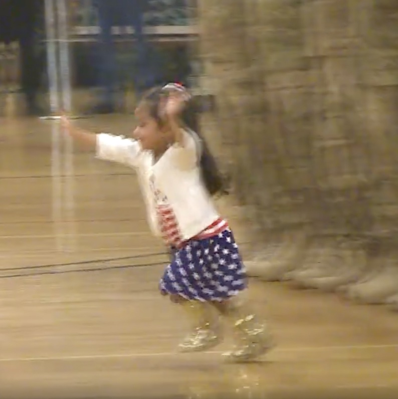 A little girl interrupts the troop's homecoming celebration to give her father a hug