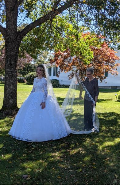 Bride walks down the aisle in her grandmother's 1961 wedding gown, which she kept in a garbage bag