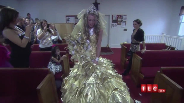 Gypsy bride married in a dress of solid gold and with a bouquet of hundred dollar bills