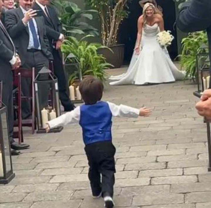It is a lovely moment when a 2 yearold toddler sees his mother dressed as a bride!