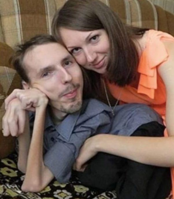This lady is holding her husband in her arms! Take a peek at this adorable couple's child!