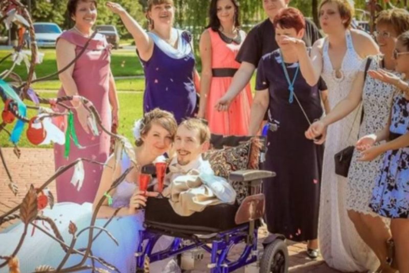 This lady is holding her husband in her arms! Take a peek at this adorable couple's child!
