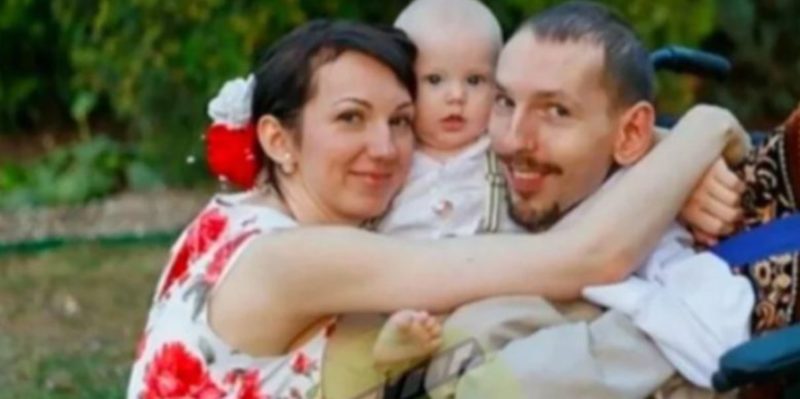 This lady is holding her husband in her arms! Take a peek at this adorable couple's child!