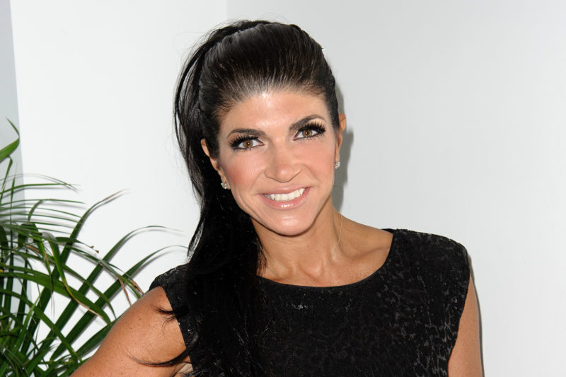 Teresa Giudice looks stunning in an orange biкini and kisses Luis Ruelas in Italy