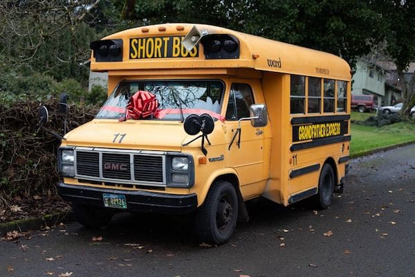 Grandpa purchased a school bus and is now transporting ten of his grandchildren to school