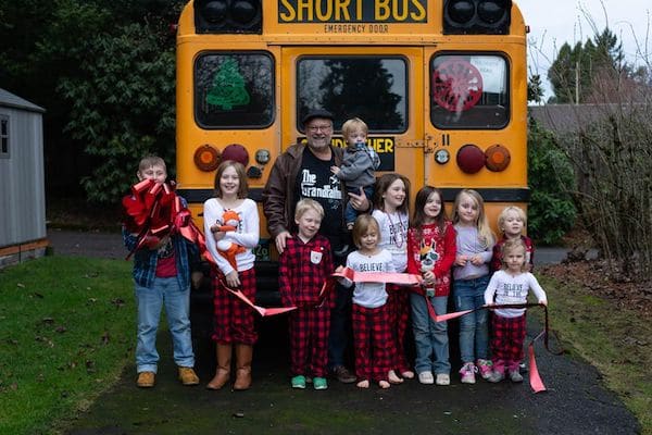 Grandpa purchased a school bus and is now transporting ten of his grandchildren to school
