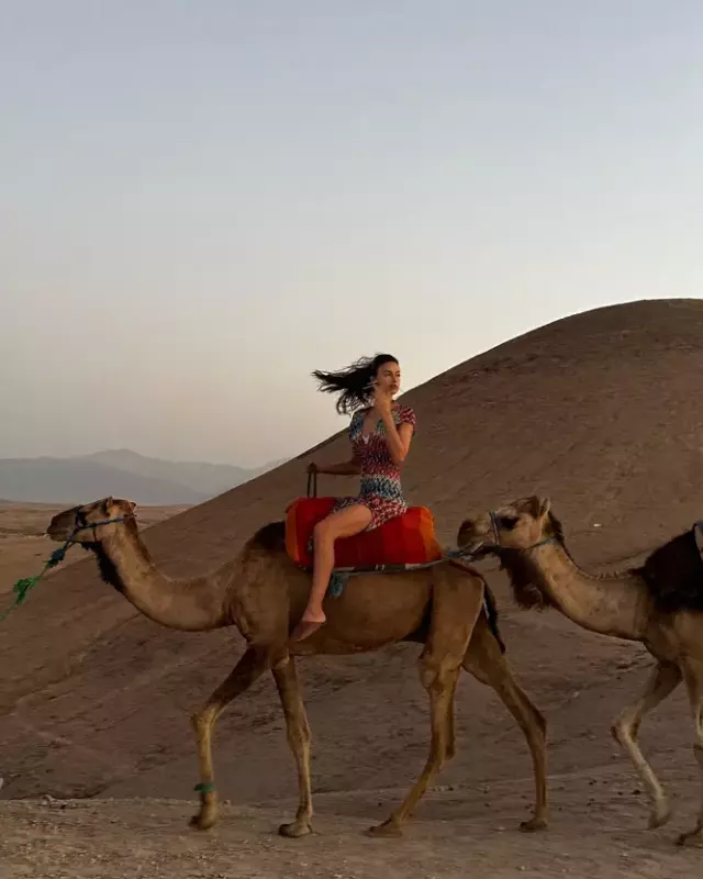 I'm in the red city! Irina in a biкini posed with a donkey and a camel