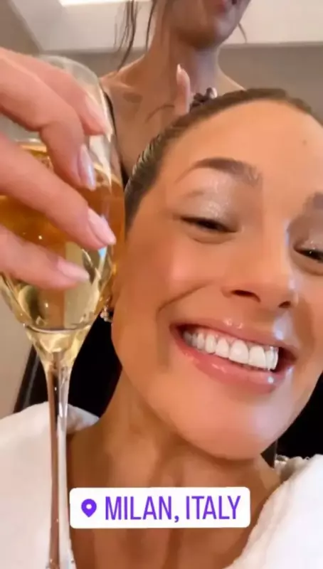 Ashley wears nothing but a tiny white robe while sipping champagne
