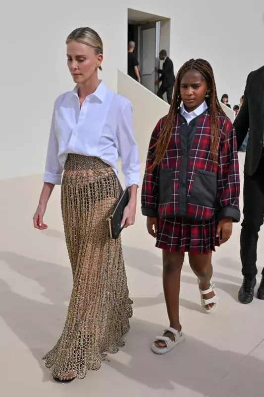 Charlize Theron in a transparent skirt appeared at a fashion show in Paris with her 11 yearold daughter