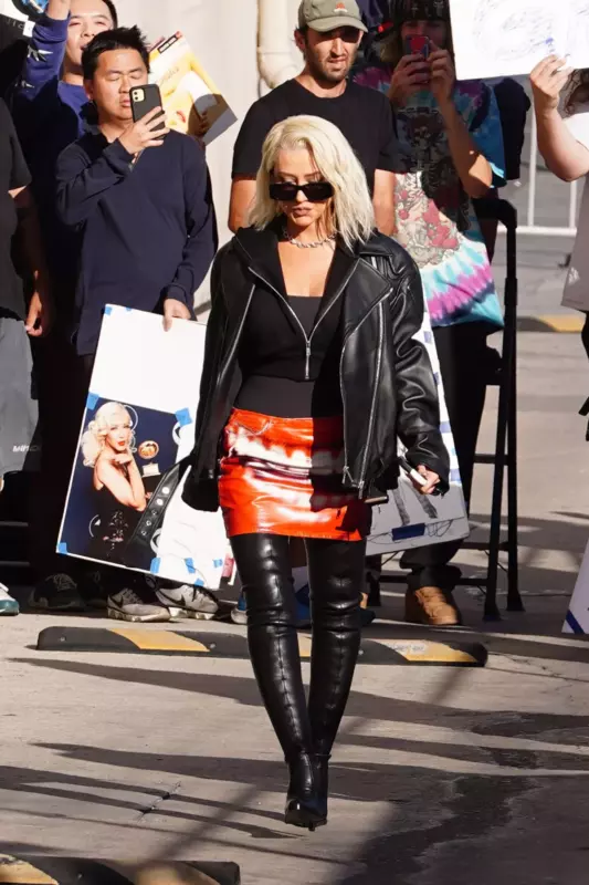 Christina Aguilera looks stunning in thigh-high leather stilettos and an extremely tiny skirt