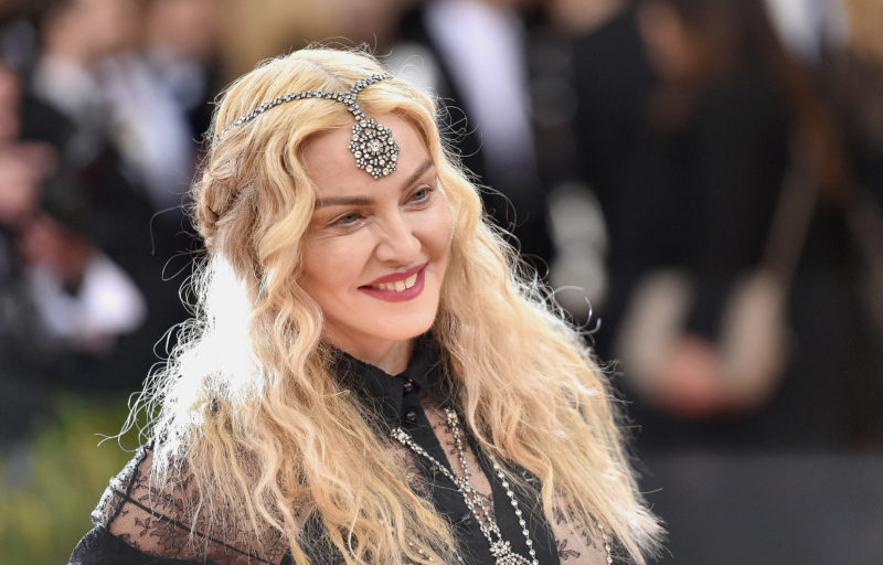 After the Dolce & Gabbana show in Milan, Madonna removes her black veil in a daring after-party ensemble
