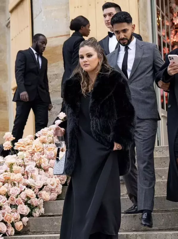 Selena Gomez in a dress with a slit and a black fur coat appeared at the wedding of her ex-boyfriend in France