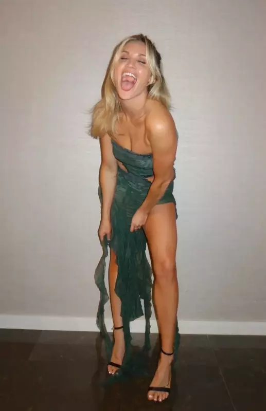 Ashley Roberts' toned legs come out from beneath her cut gown with a wide thigh split.