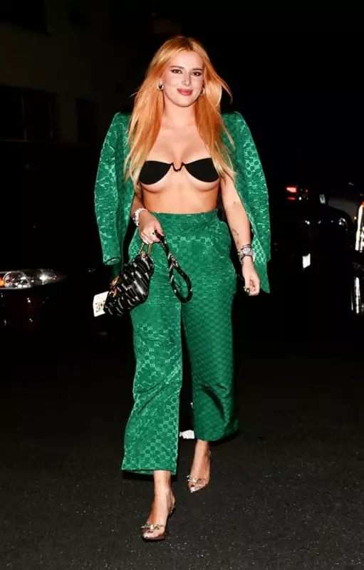 Bella Thorne wears hot animal-print biкini while lounging on the beach for holiday vacation