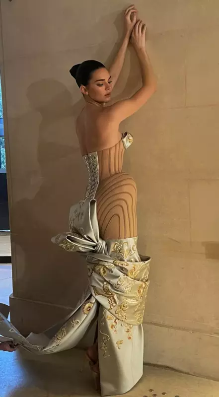 Dress of dreams, a waist-whittling gown that resembles an optical illusion, is worn by Kendall Jenner as she walks the runway